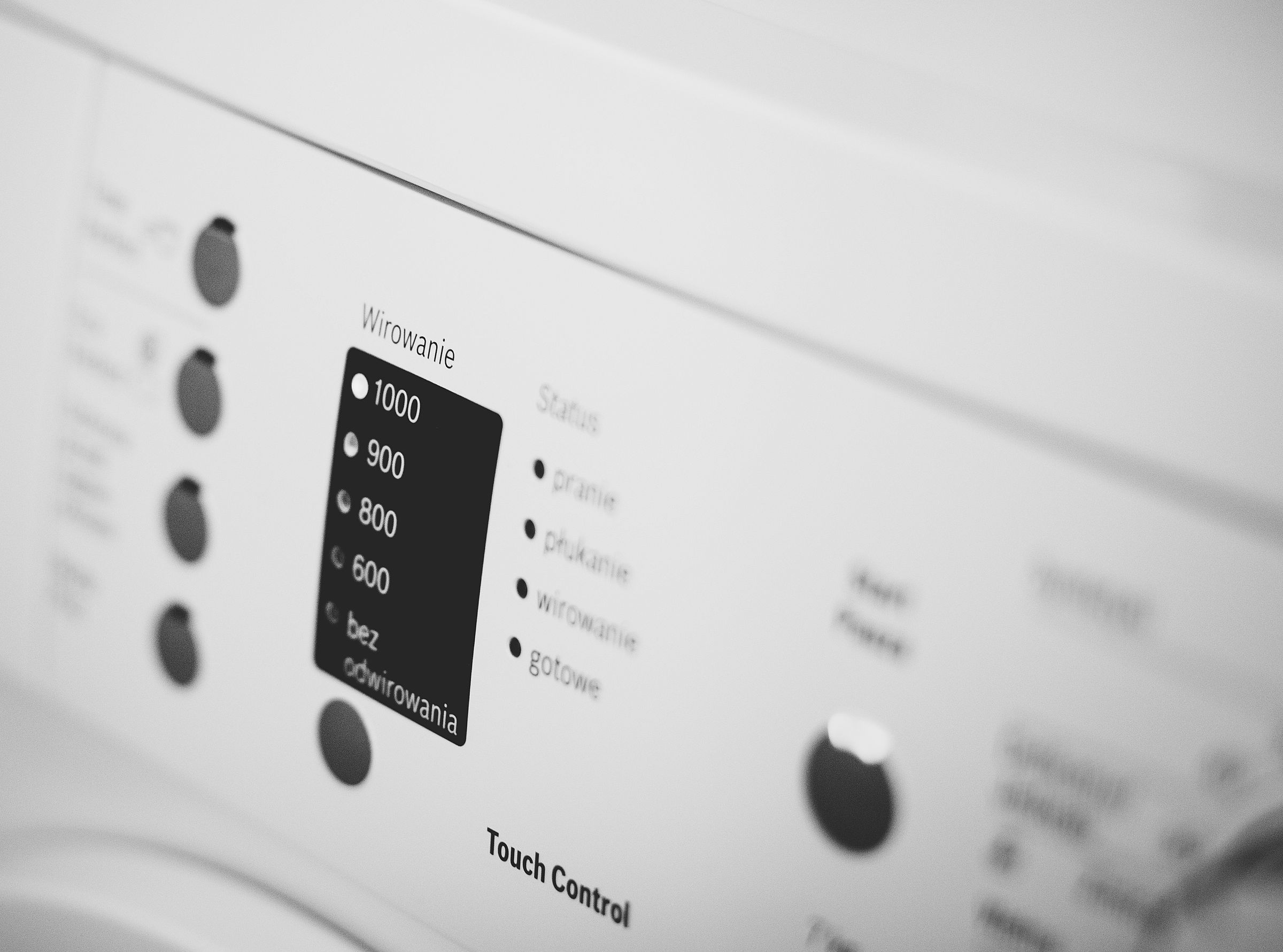Control panel of a white front-load washing machine